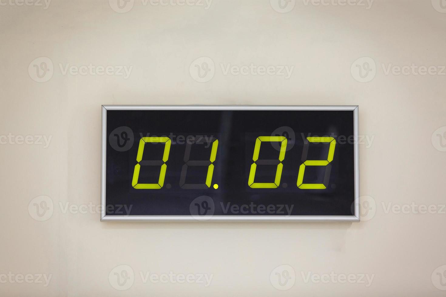 Black digital clock on a white background showing time   Closeup group date calendar 01.02 photo