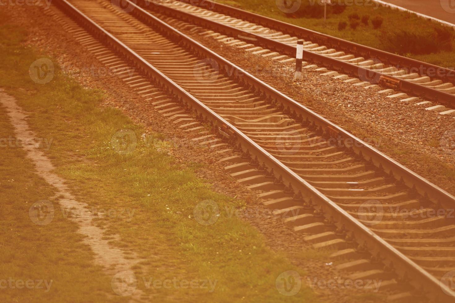 Two railways tracks merge close up photo