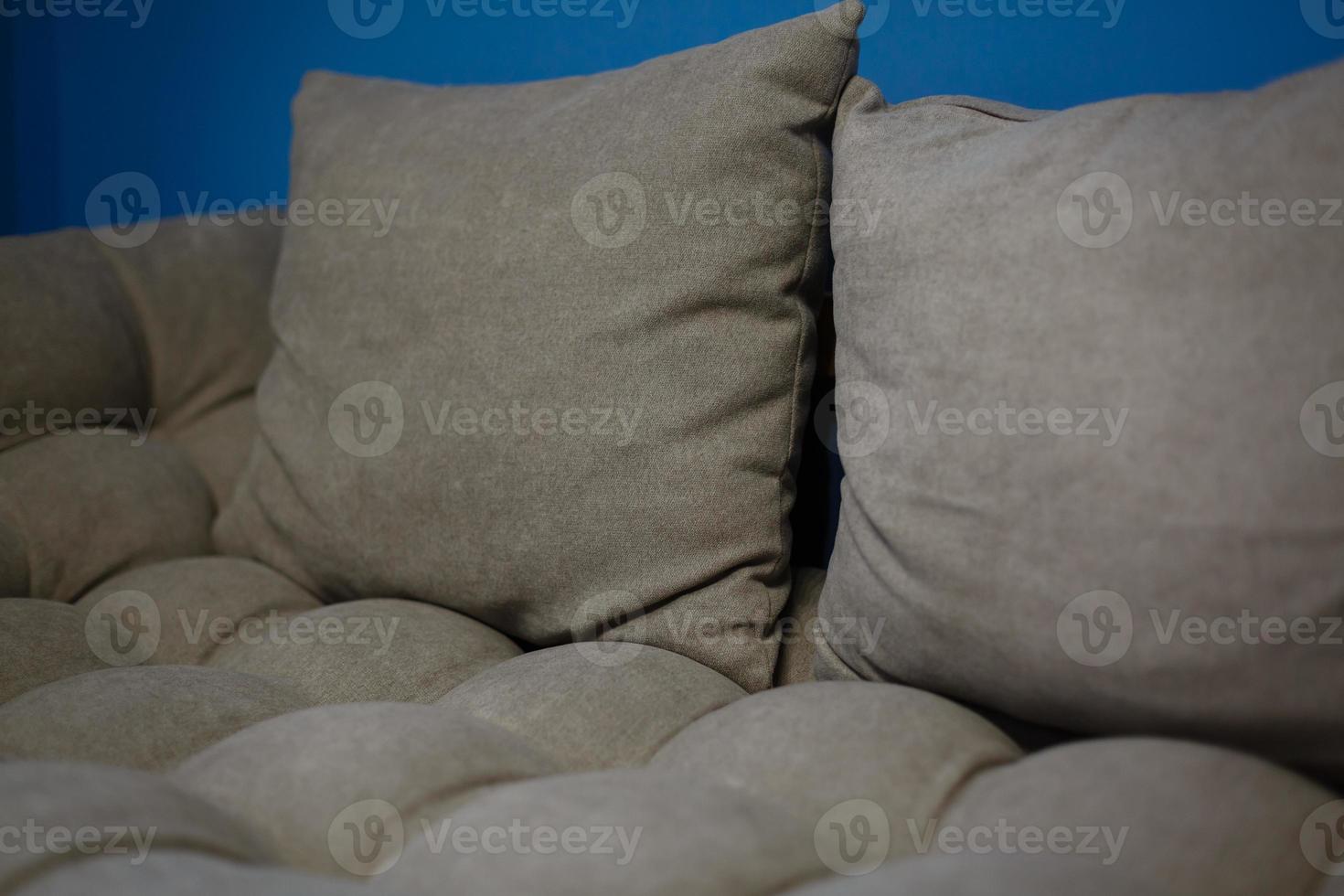 Modern white design sofa against blue wall photo