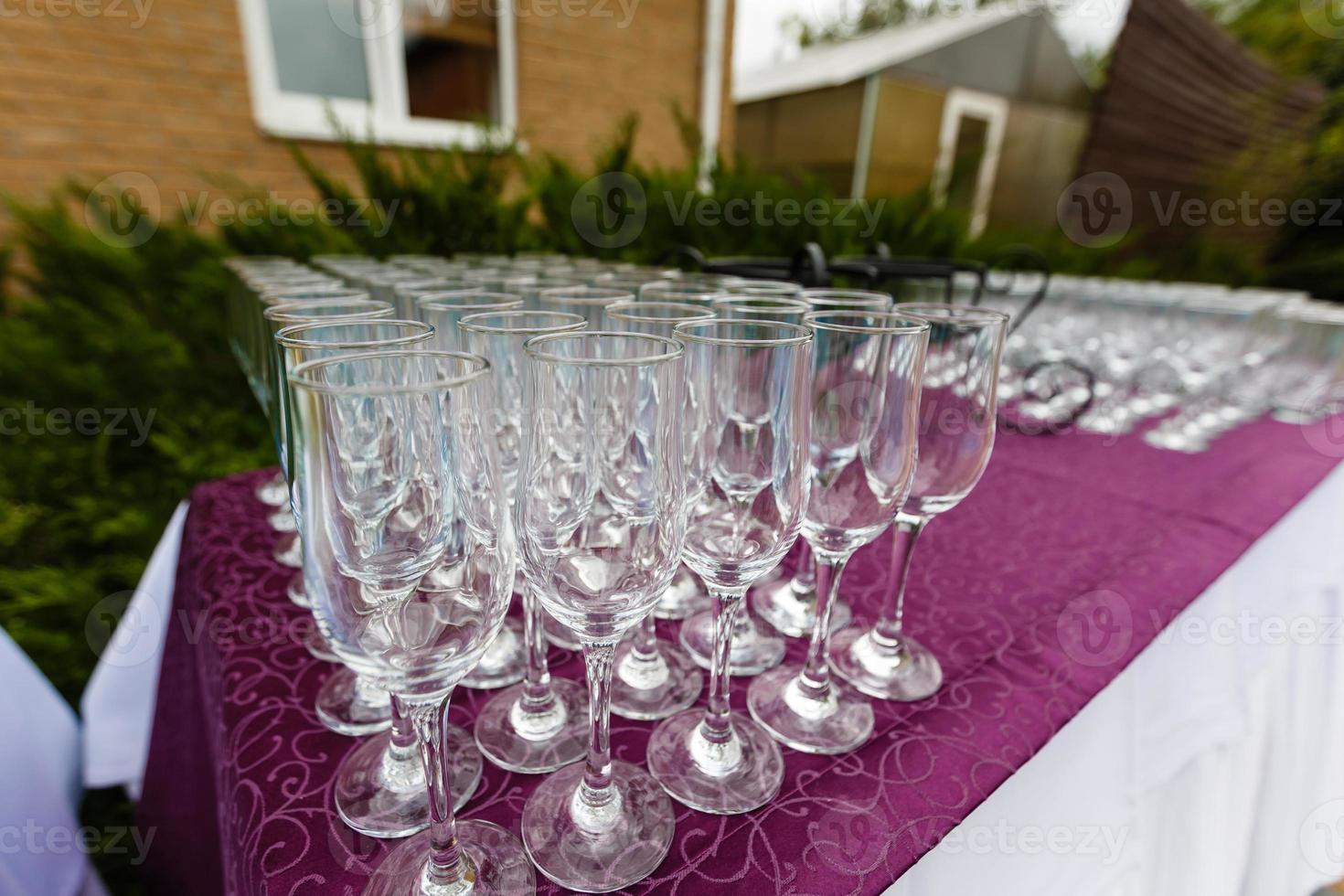 Beautiful champagne glasses defocused on buffet table in restaurant and blurred background photo