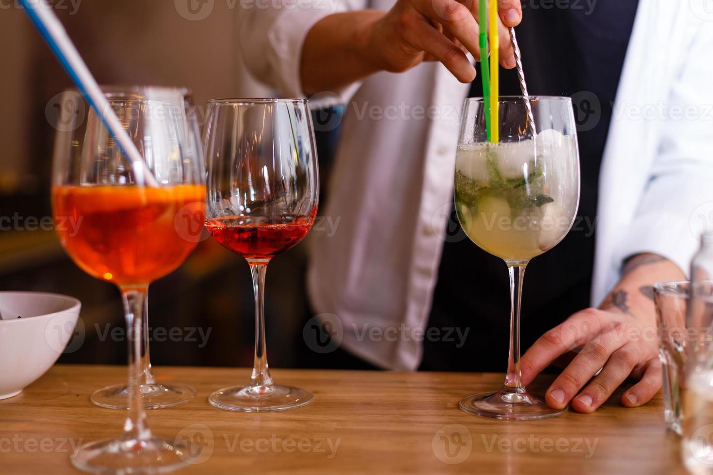 Bartender putting broken ice in a glass photo