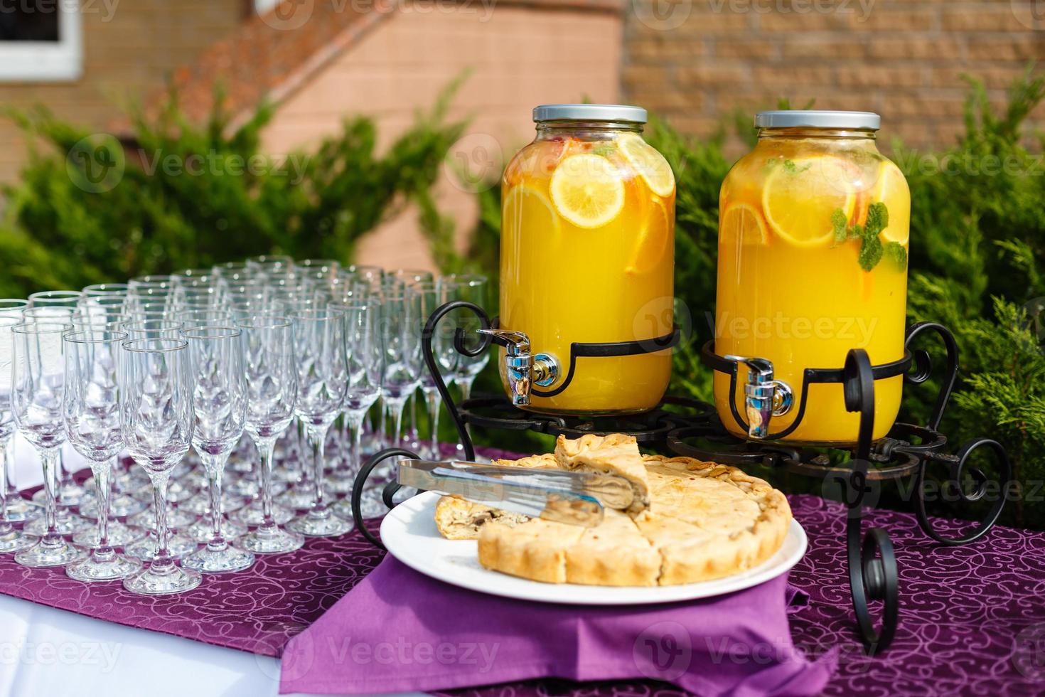 Bank of lemonade with citrus fruits on a buffet table photo