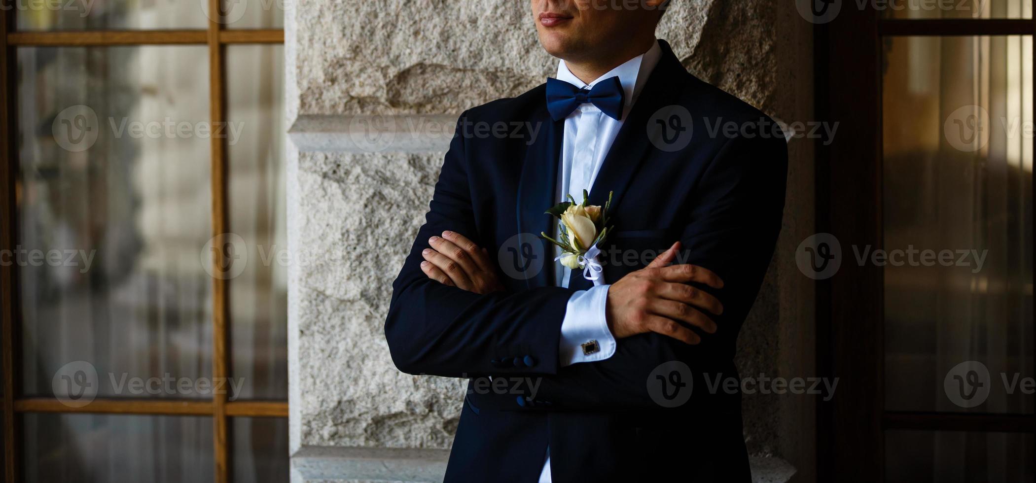 Sexy man in tuxedo and bow tie posing photo