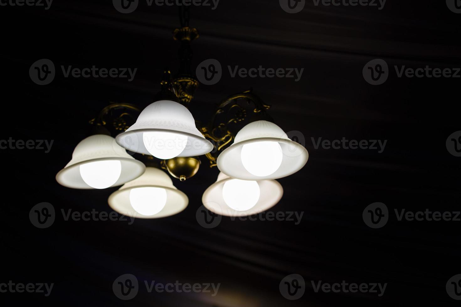 Vintage chandelier isolated on black background with clipping path photo