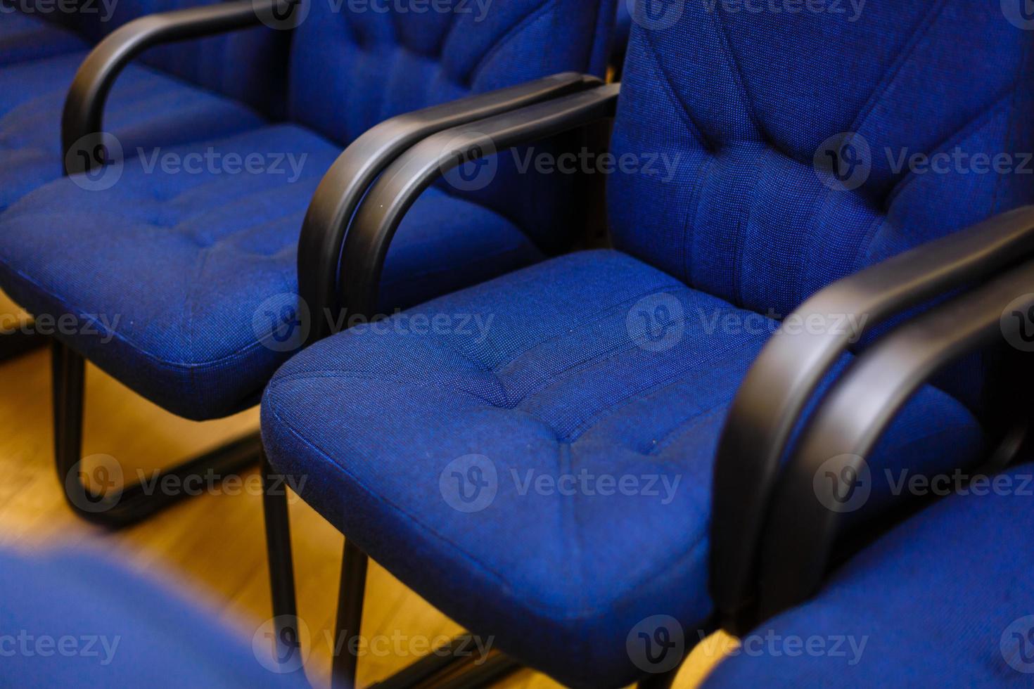 Rows of chairs at a conference, in an audience or at a training photo