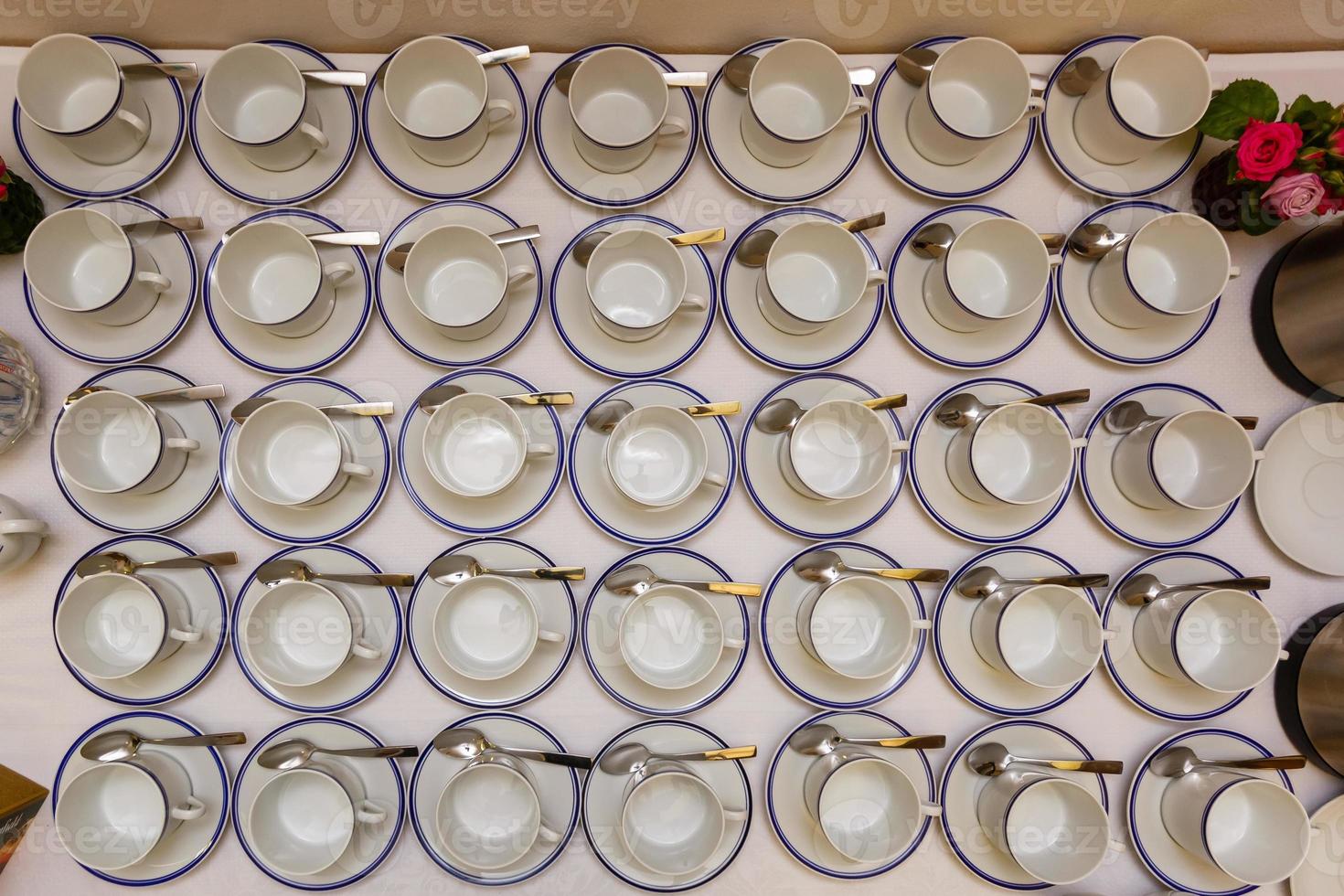 Looking down from above at lots of take away coffee cups all empty on a wooden background photo
