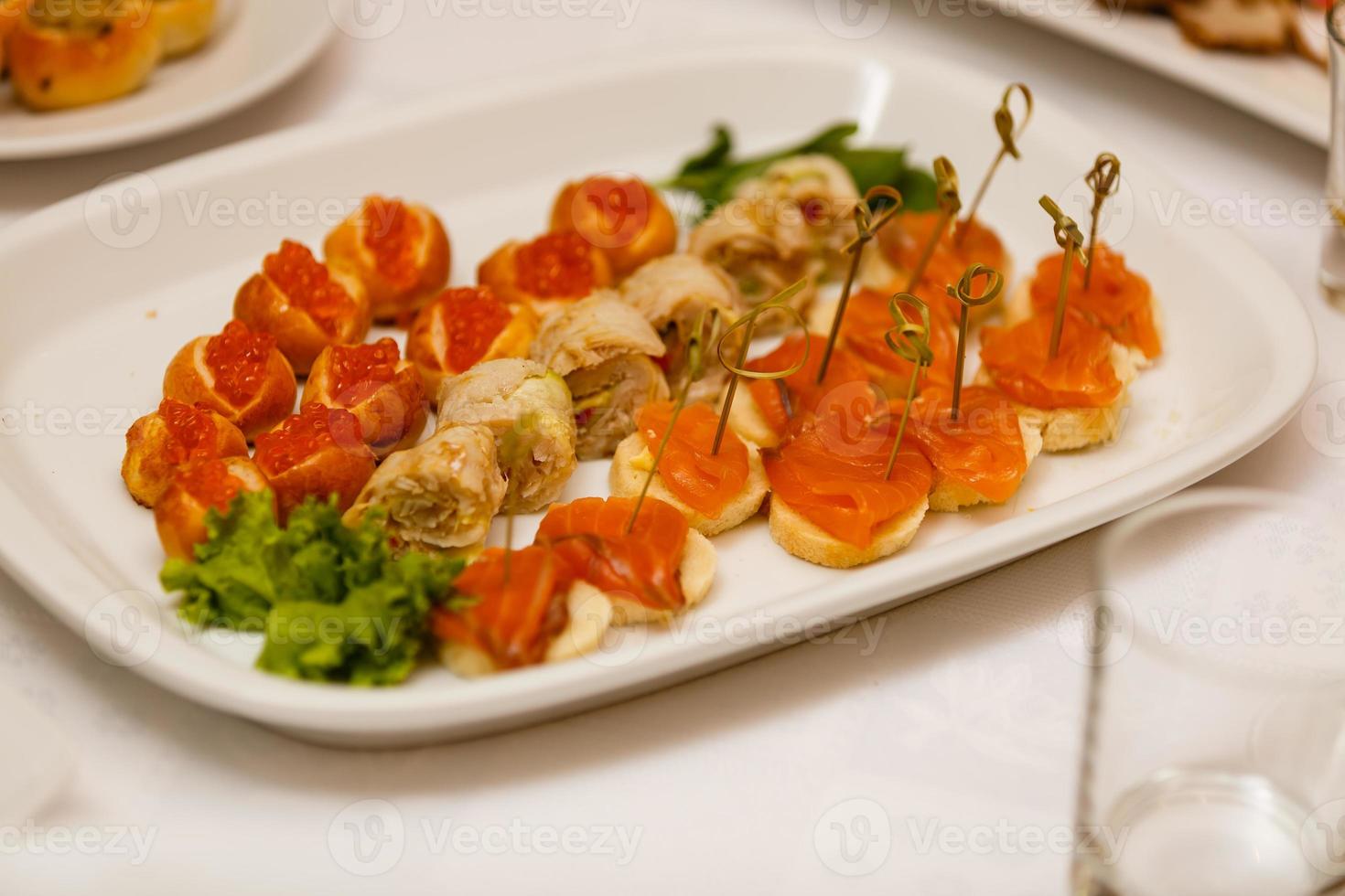 Delicious buffet table at a luxury event spread with a variety of cold meat platters and fresh colorful salad and vegetables photo