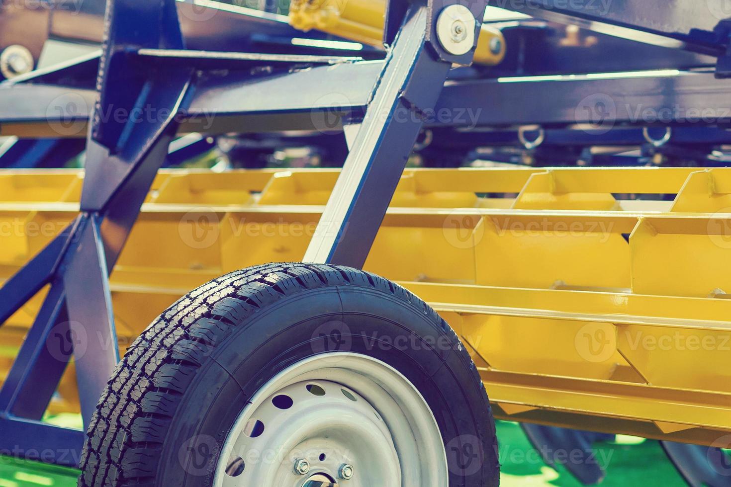 Agriculture equipment concept. Detailed closeup agricultural machinery, big wheels with tires. Outdoor shot photo