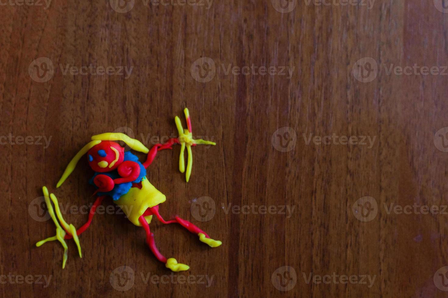 Doll from colorful clay dough plasticine made by child photo