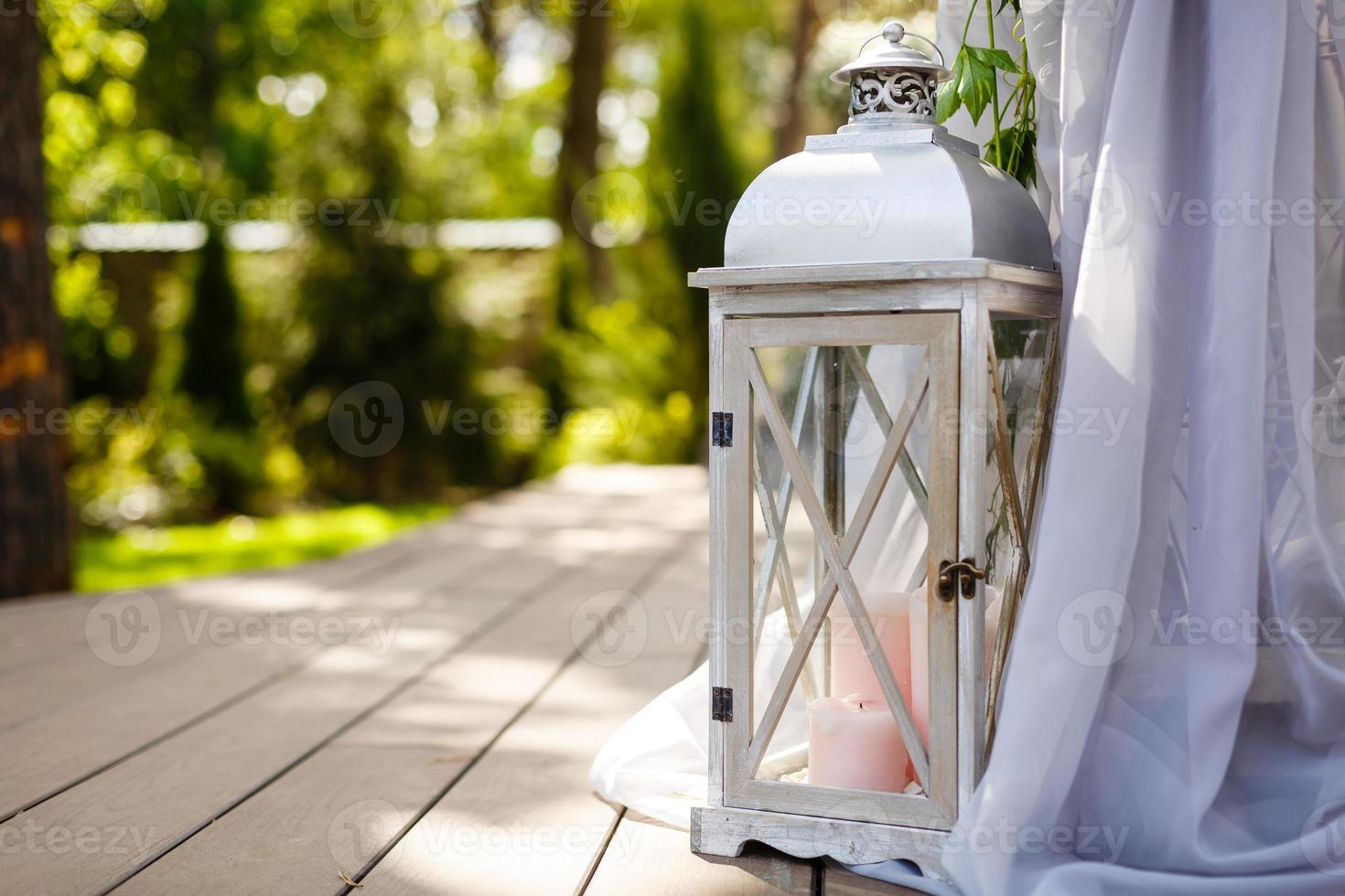 Wooden candlestick with white candles on beige cloth background photo