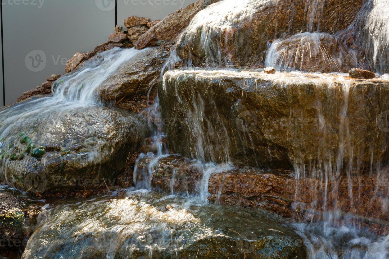 Close up of water splashing on rocks from a waterfall photo