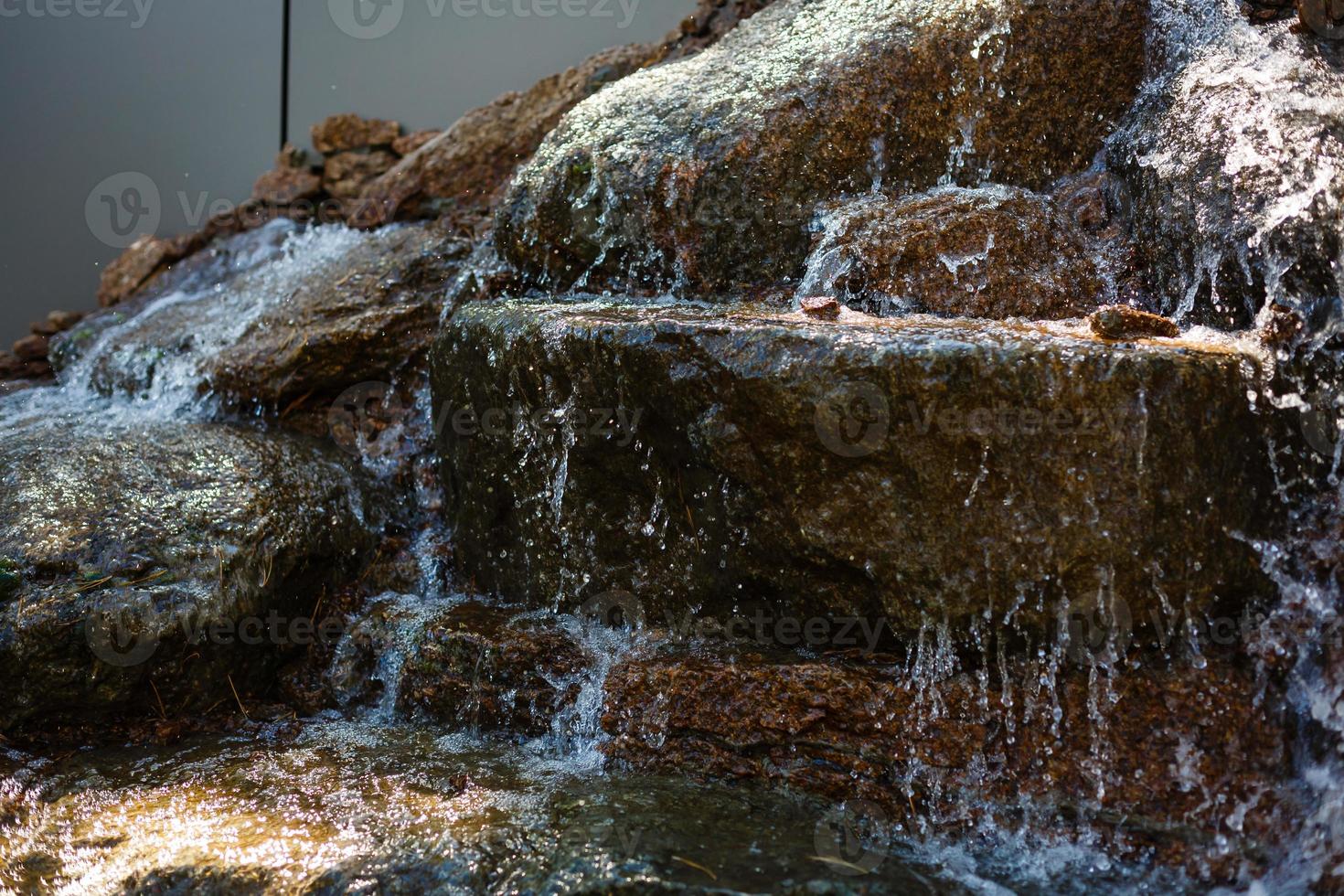 Close up of water splashing on rocks from a waterfall photo