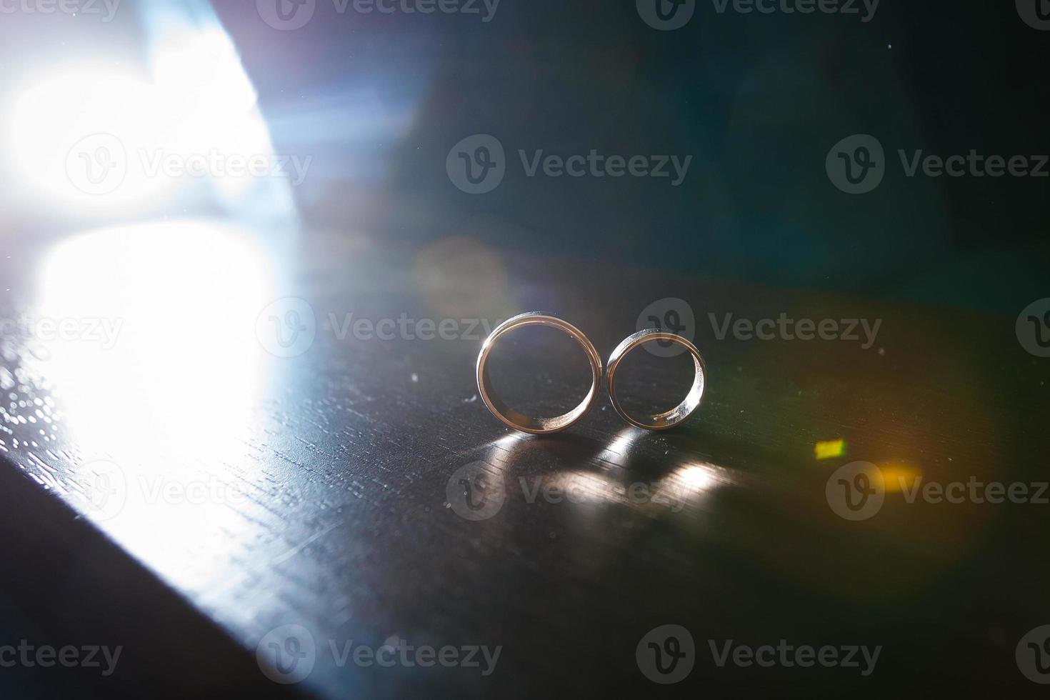 Couple wedding rings on old wood texture photo