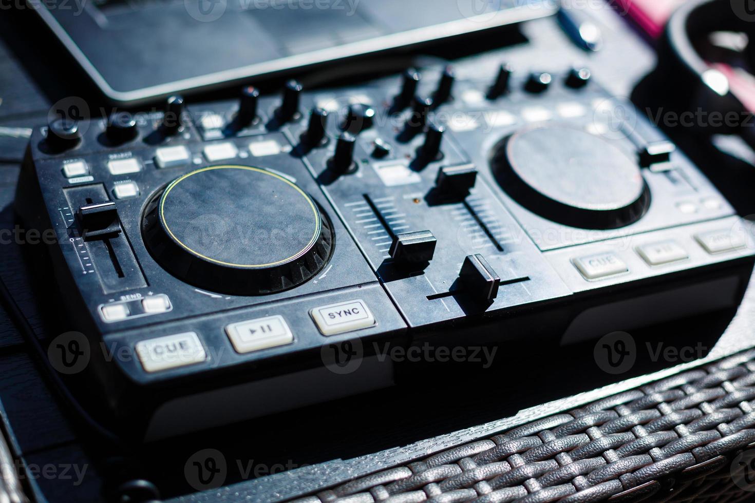 Dj mixer with headphones on wooden table close-up. photo