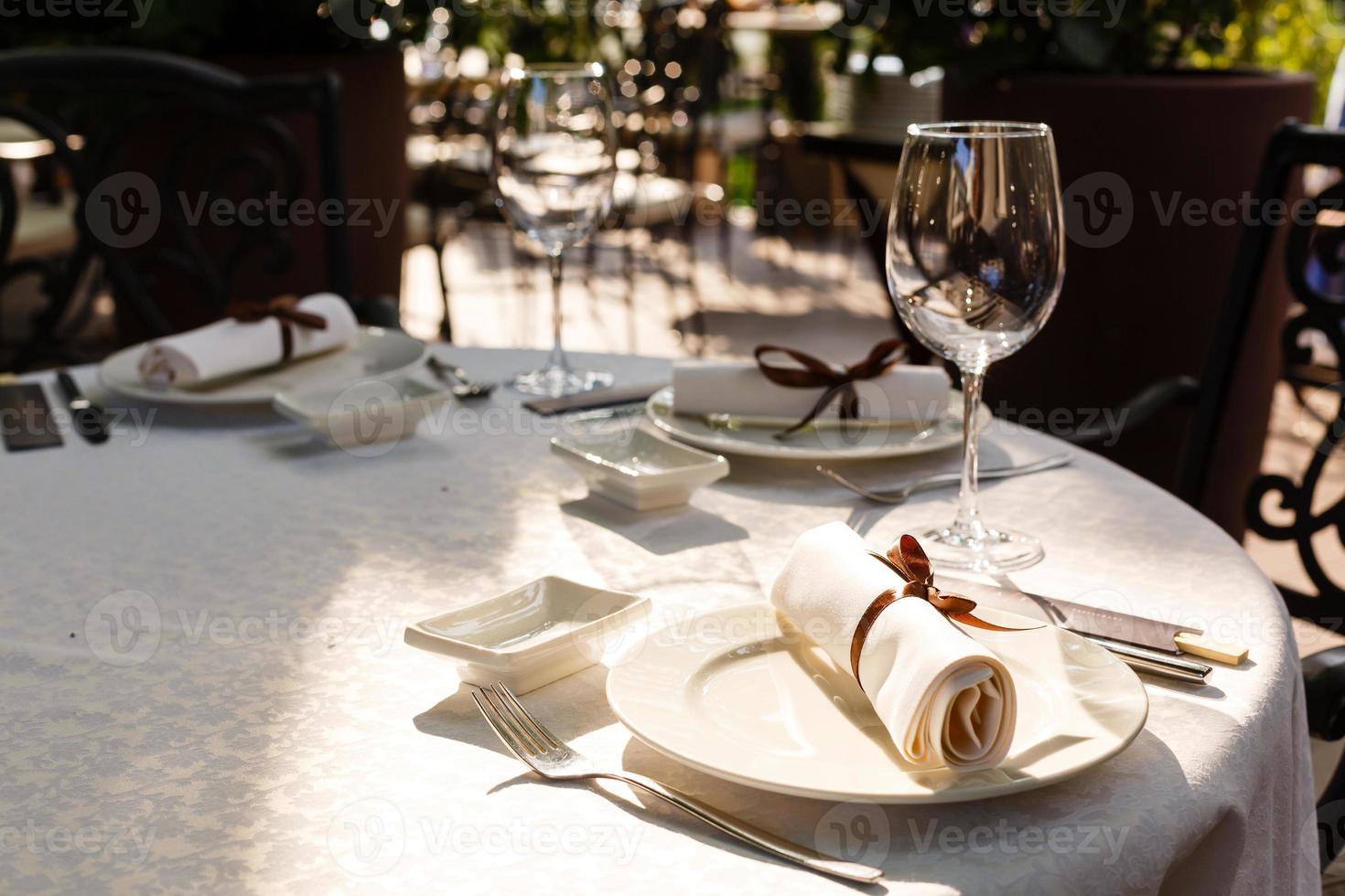 Served table in restaurant with dishes and glasses photo