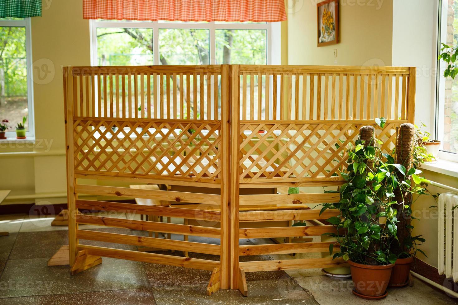 Fence of crossed wooden slats for outdoor cafes. photo