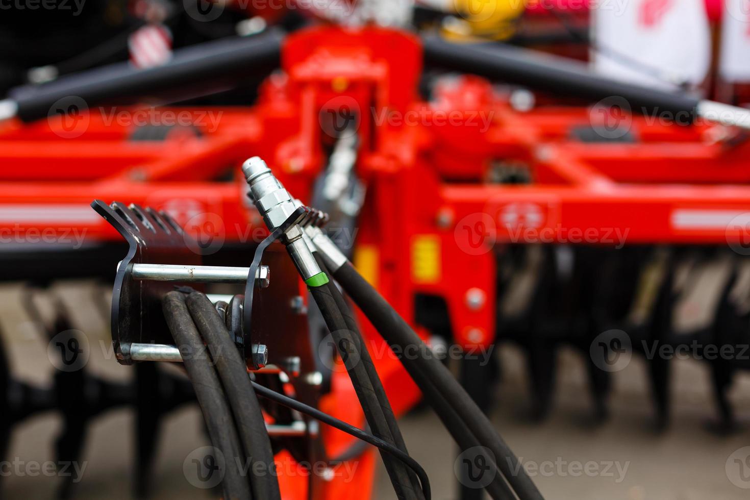 Close up of pipe system of hydraulic valves in agricultural machinery photo