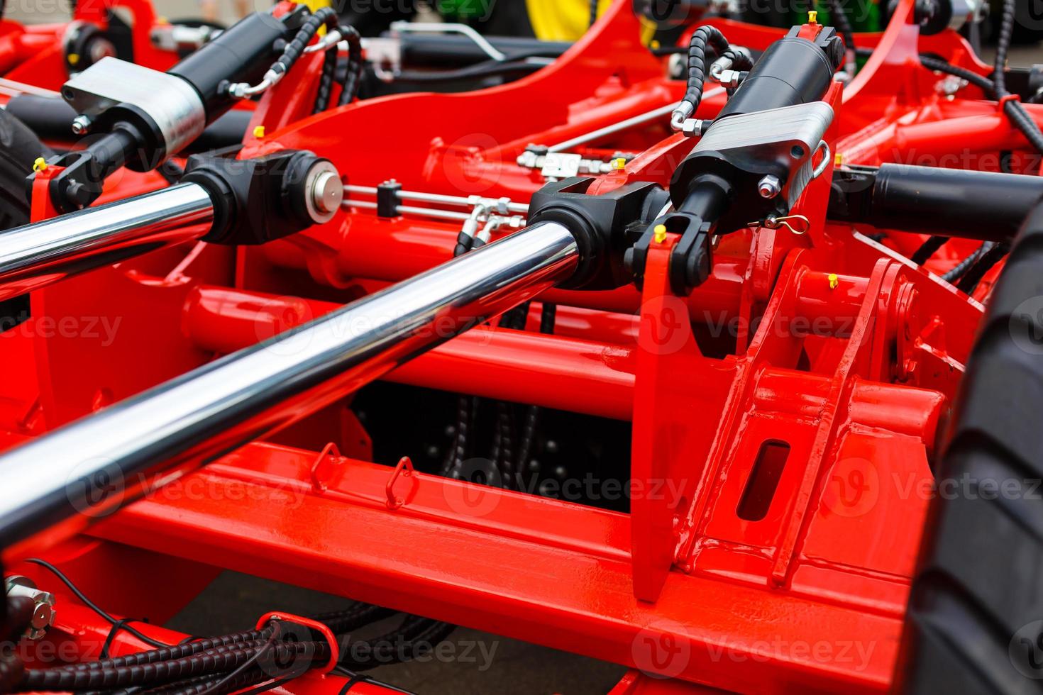 Close up of pipe system of hydraulic valves in agricultural machinery photo