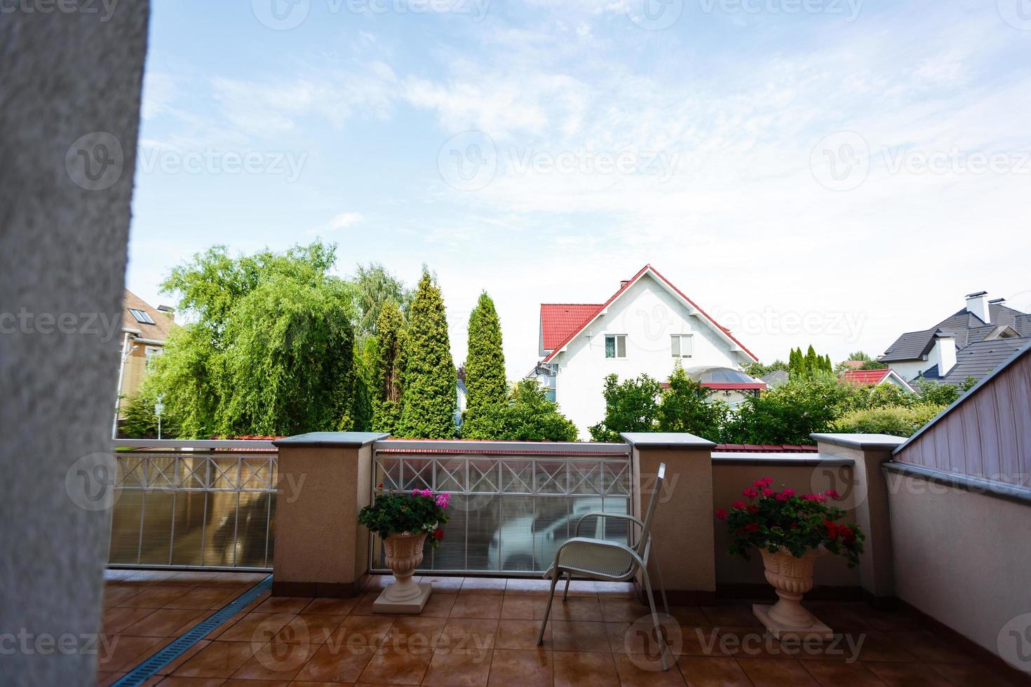 Large balcony with fenced garden view. photo