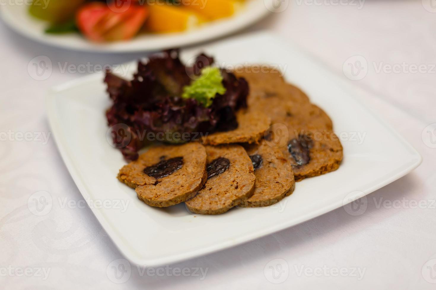 Dish with sliced meat products on the festive table photo