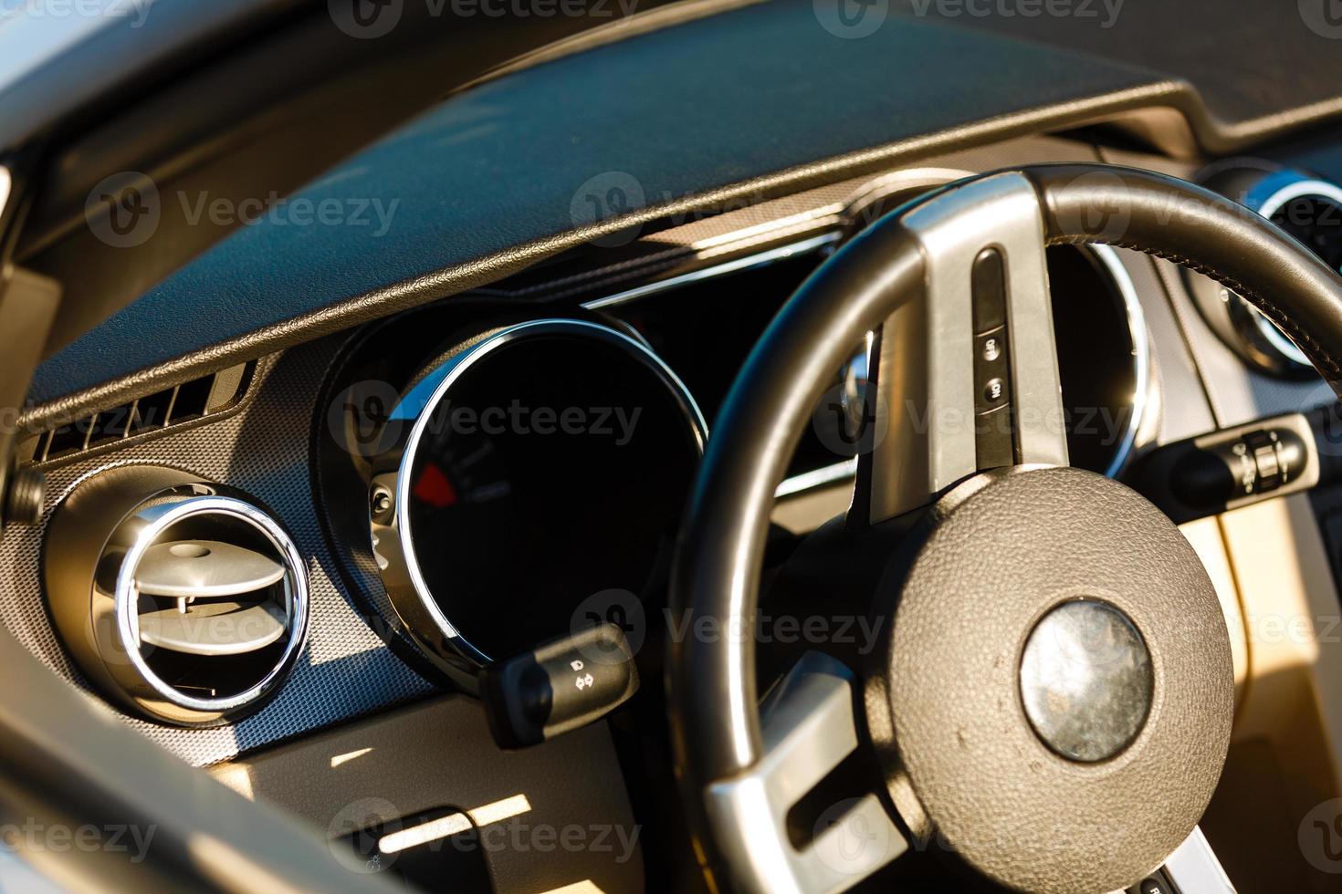 Closeup interior modern car console with full windscreen show space of front seat and passenger cabin , gear box , steering wheel and whole of dashboard function. photo