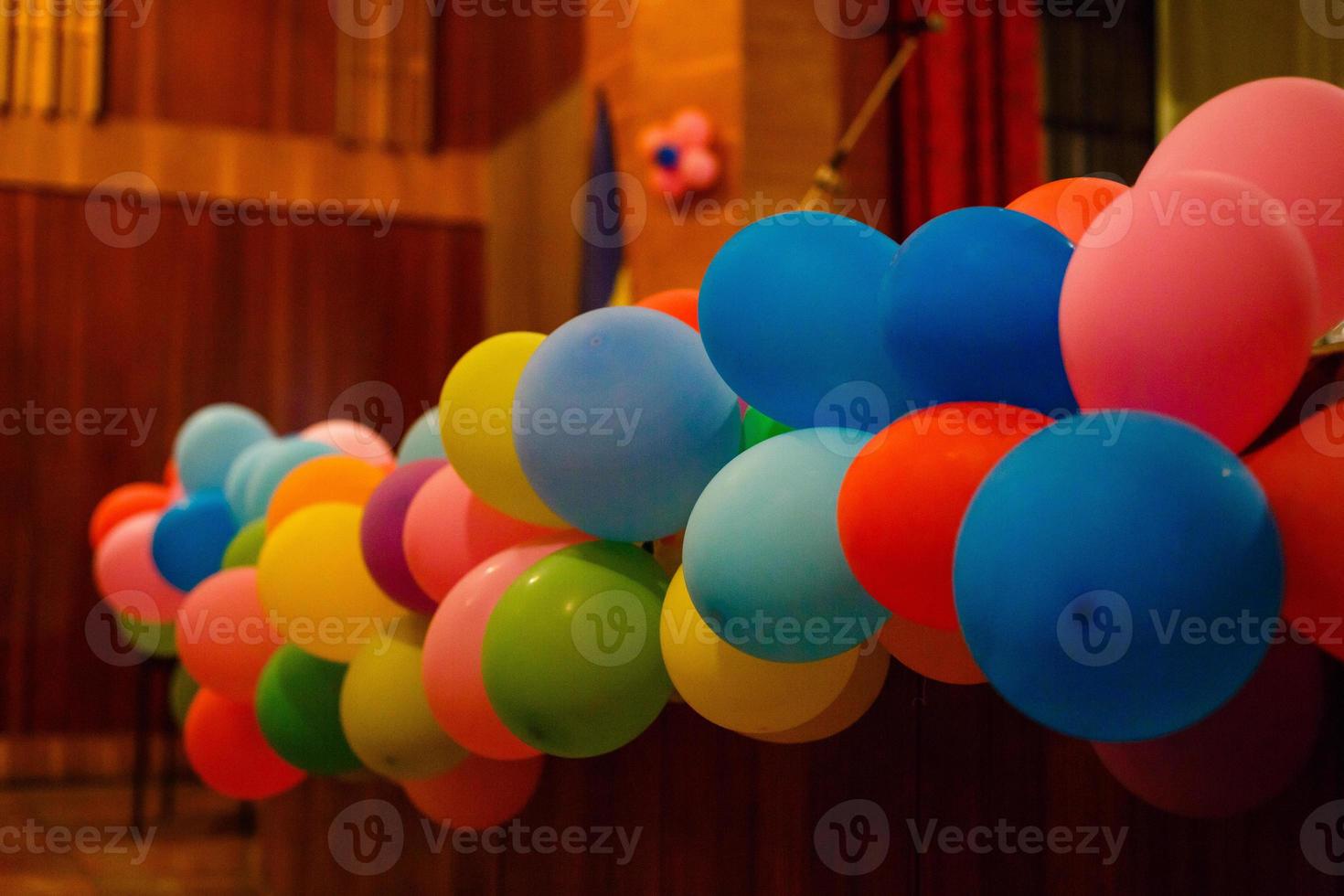 Color balls, colored polymer gel, hydrogel beads against the background of the wall and the falling rays of the sun emanating from the window. Concept holiday, birthday, congratulations photo