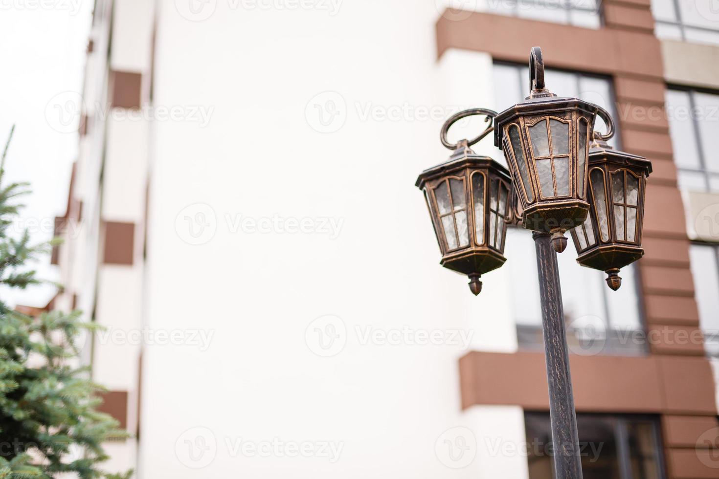 Beautiful decorative old street lamp on bricks wall photo