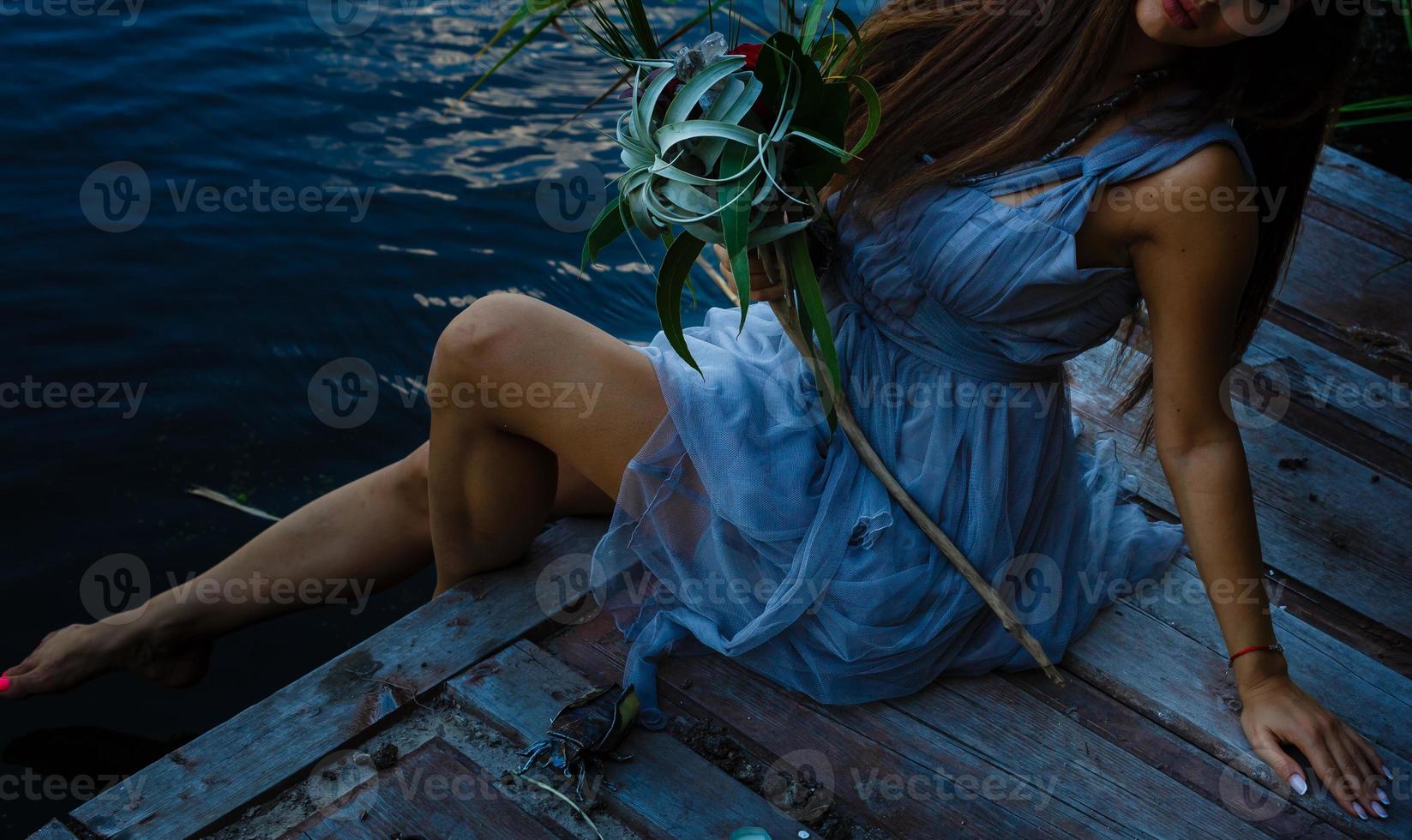 Girl is sitting in reeds photo