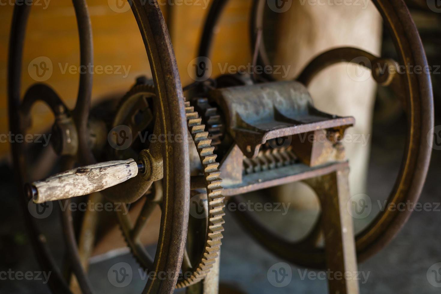 very old spinning wheel and a spindle photo