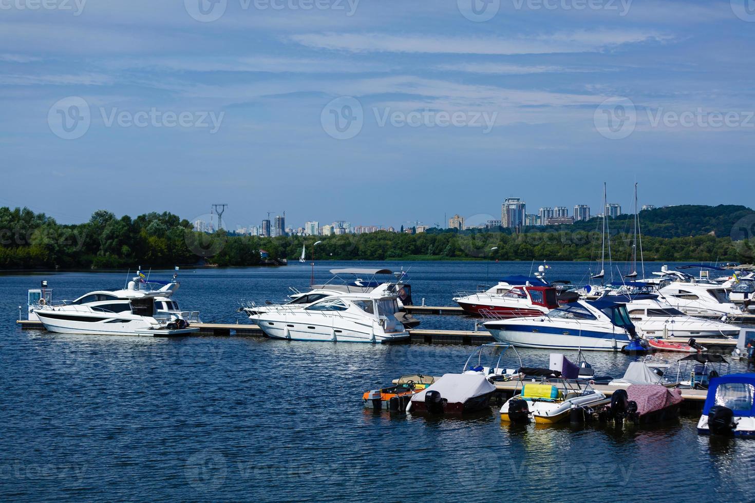 Boats anchored on the bank of the river, across the river residential houses, wide river, rest place photo