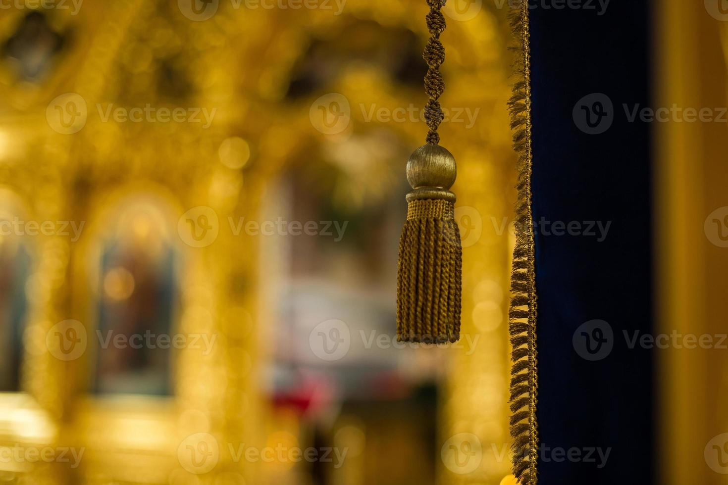 Golden tassel on a gold background photo