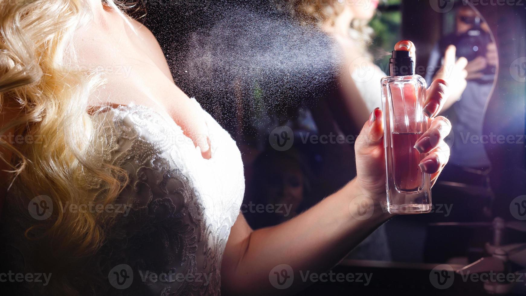 close up of spray on woman body isolated black photo