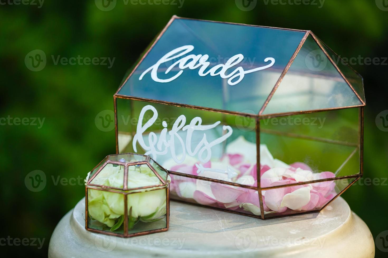 stylish decorated glass box for wedding greetings and cards and gifts at the reception in a restaurant photo