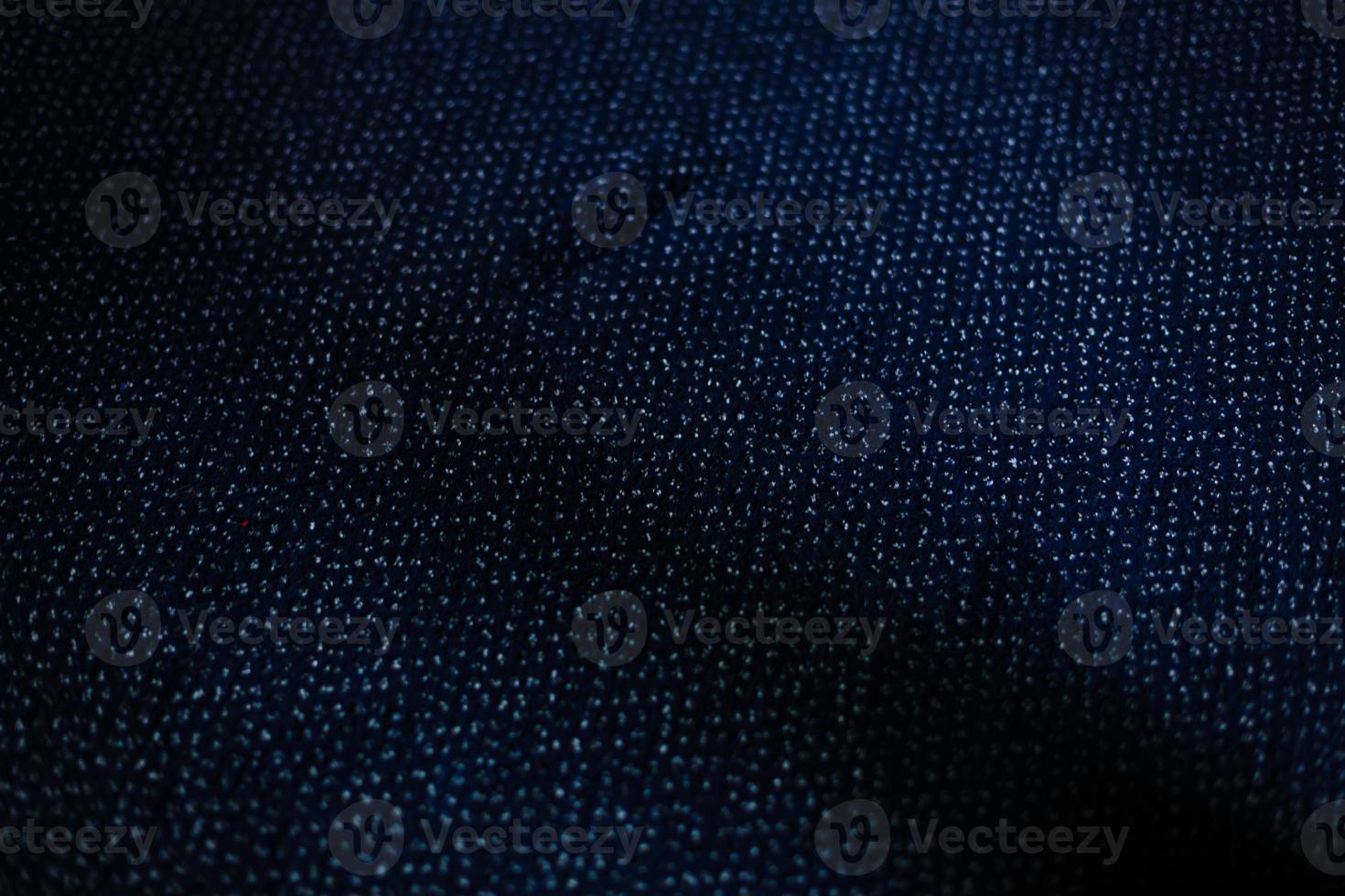 a dark blue texture or background with small loops photo