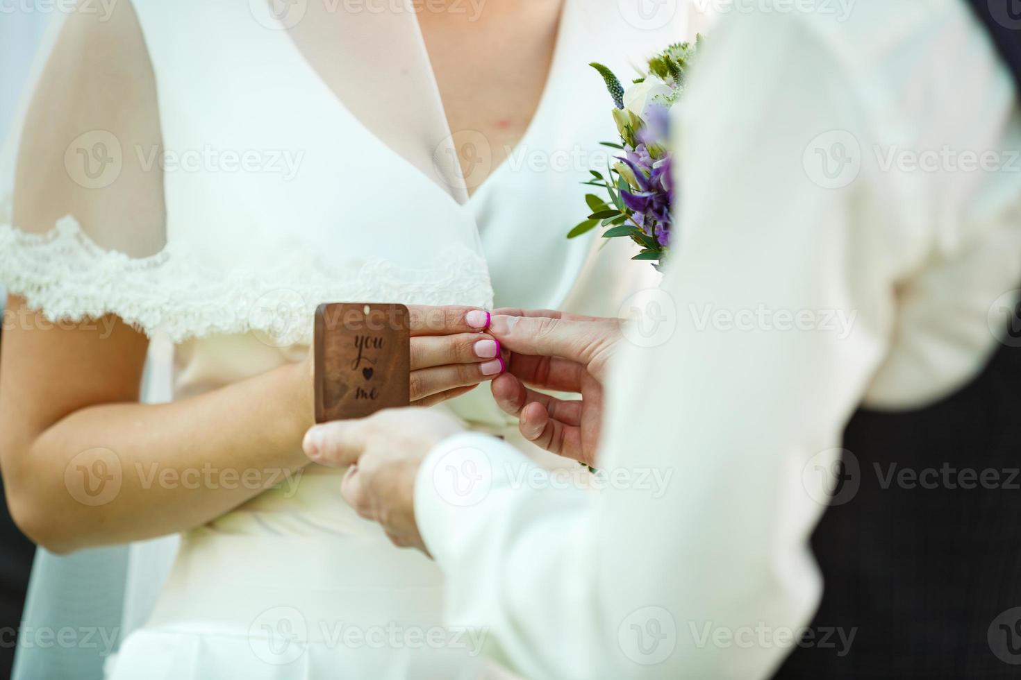 The bride and groom exchange rings during a wedding ceremony, a wedding in the summer garden photo