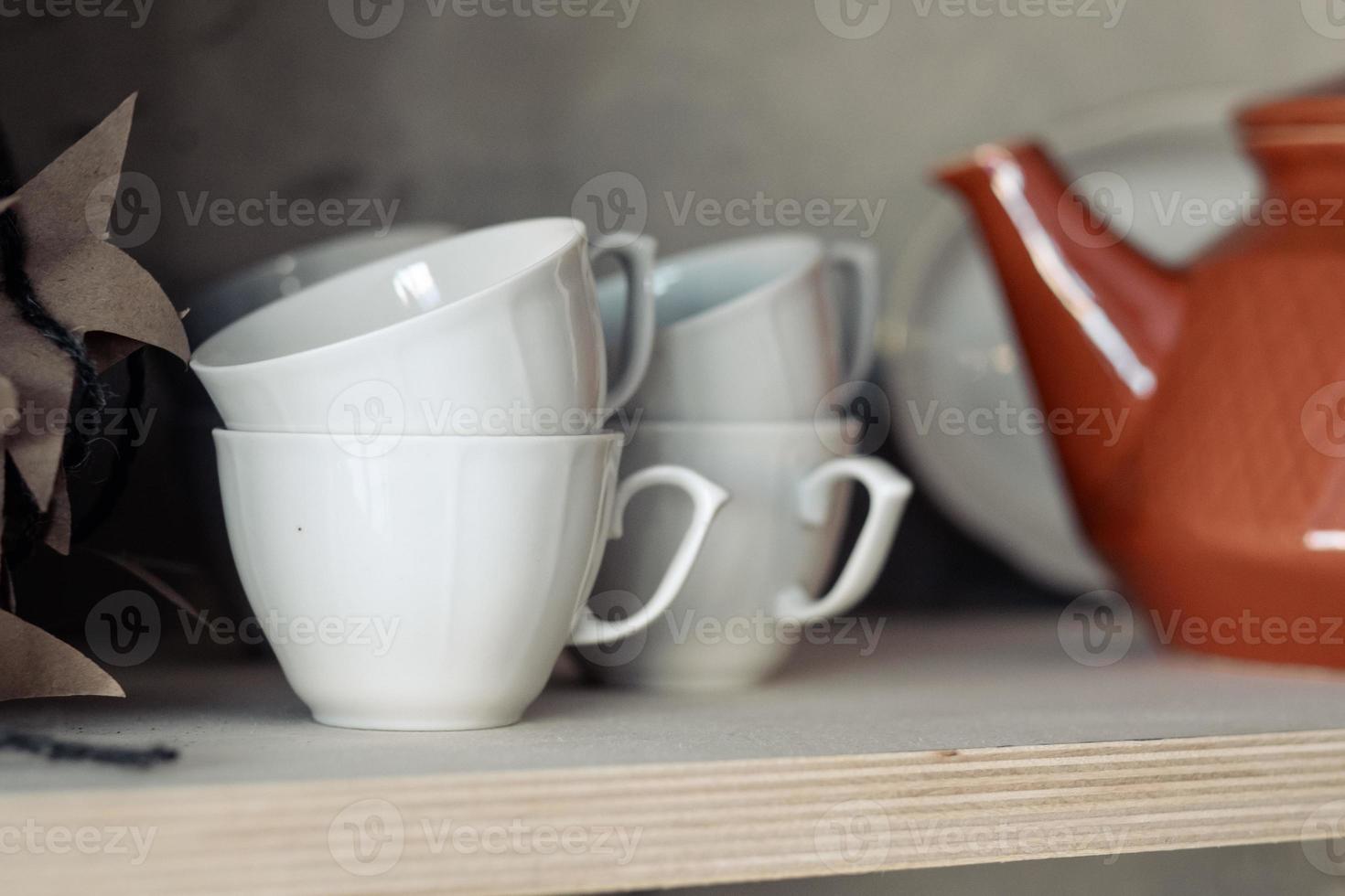 white cups on the shelf close-up photo