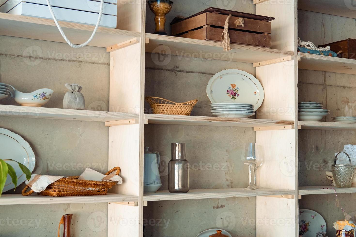 shelf with vintage dishes and other items in the dining room. photo