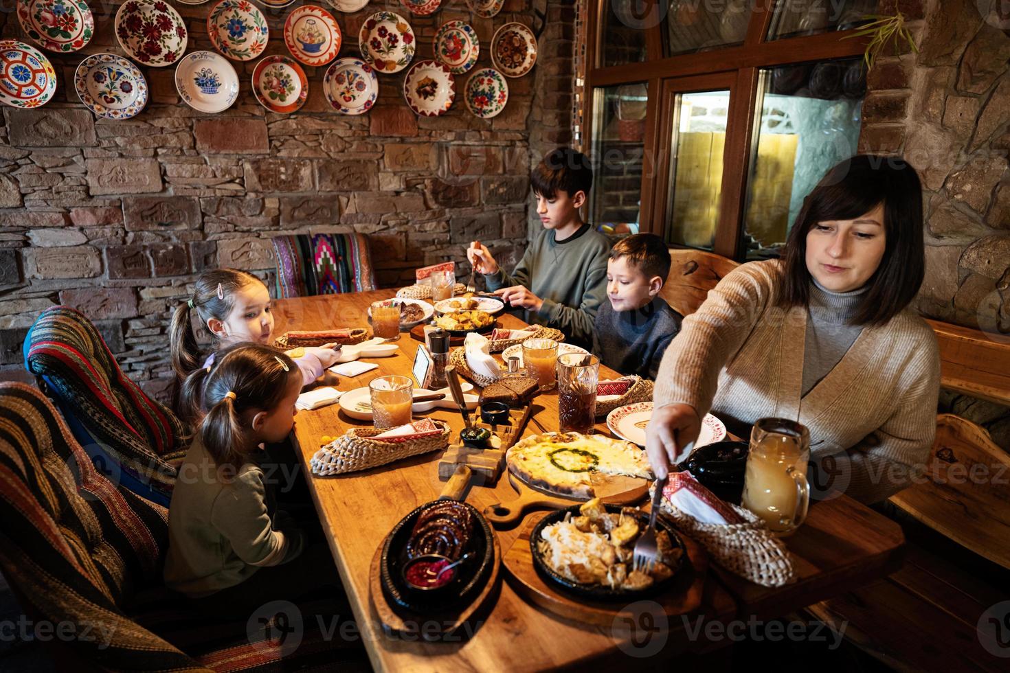 Family having a meal together in authentic ukrainian restaurant. photo