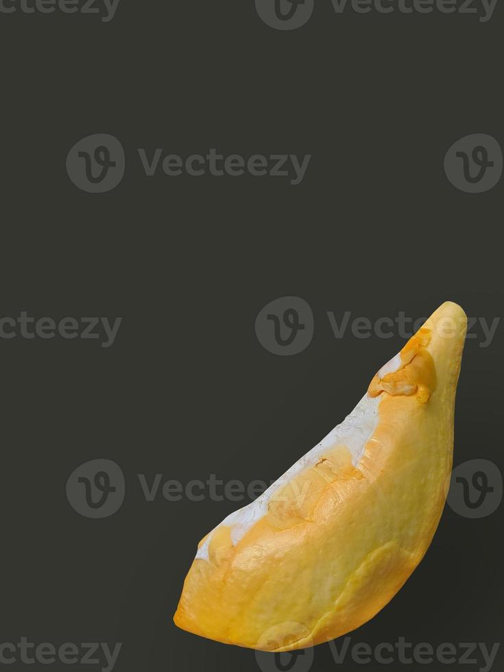 Close up a Golden yellow color of Durian meat, sweet taste, natural shape and form, Tropical seasonal fruit, king of fruit, Thailand, dark background, isolated, cutout, with clipping path photo