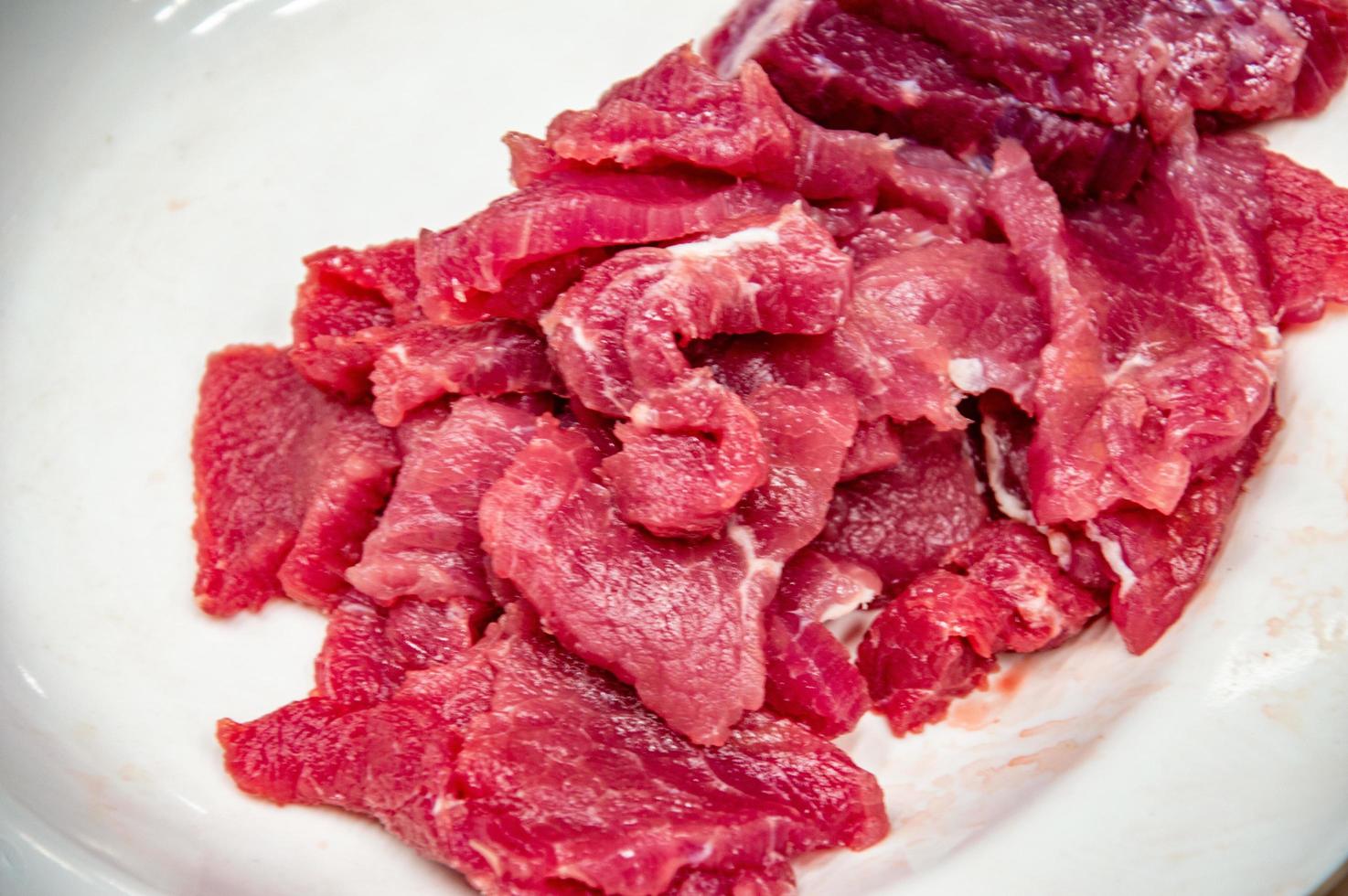 Fresh red beef on a white plate. Slaughterhouse. Butcher's shop. Pork. photo