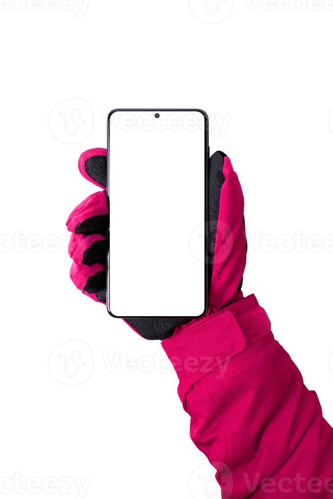 Woman hand with glove holding smart phone in front vertical position. Isolated display and background for mockup photo