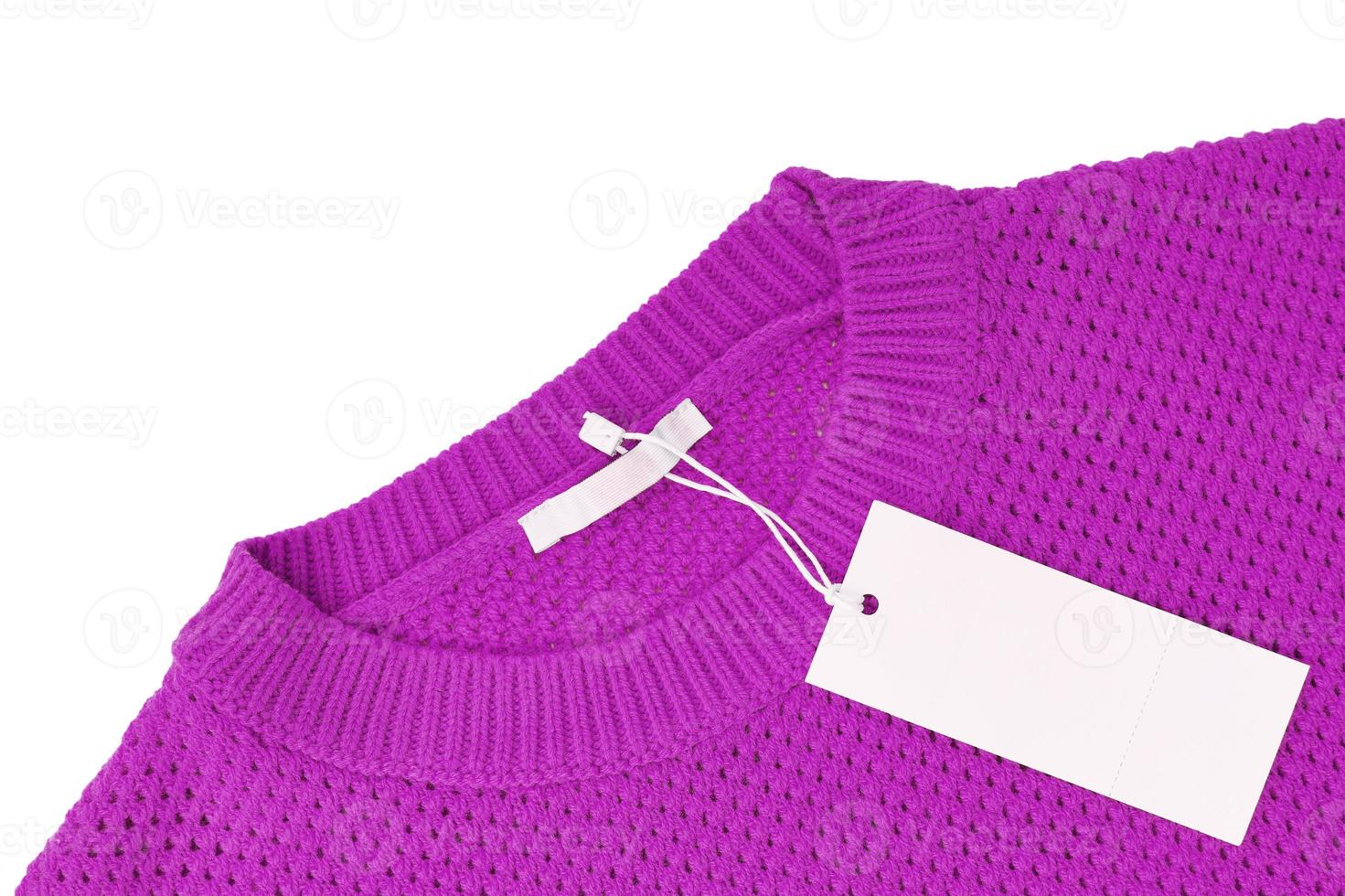 White blank rectangular clothing tag on purple knitted sweater isolated on white background photo