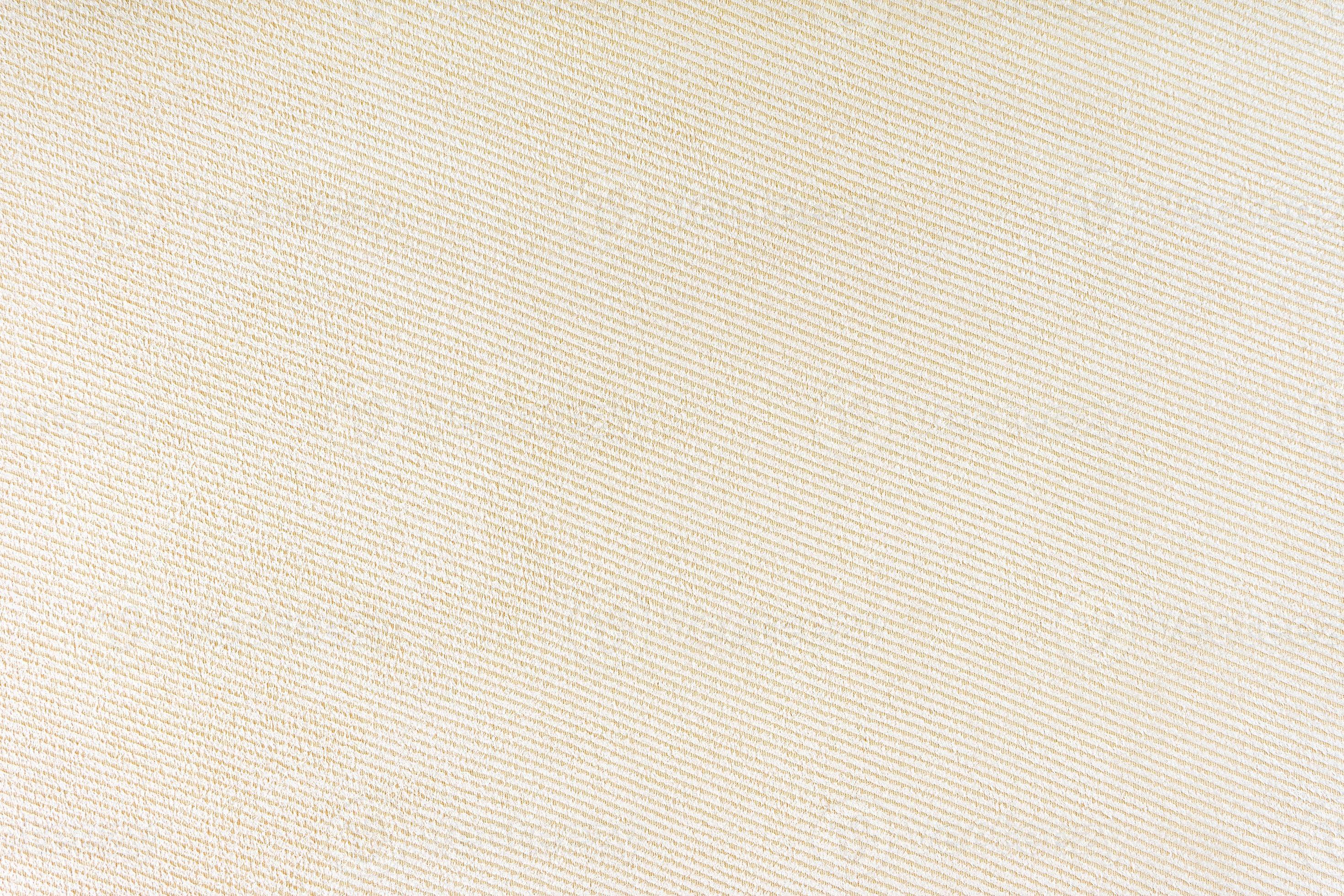 Texture of beige fabric diagonal weave pattern. Decorative textile