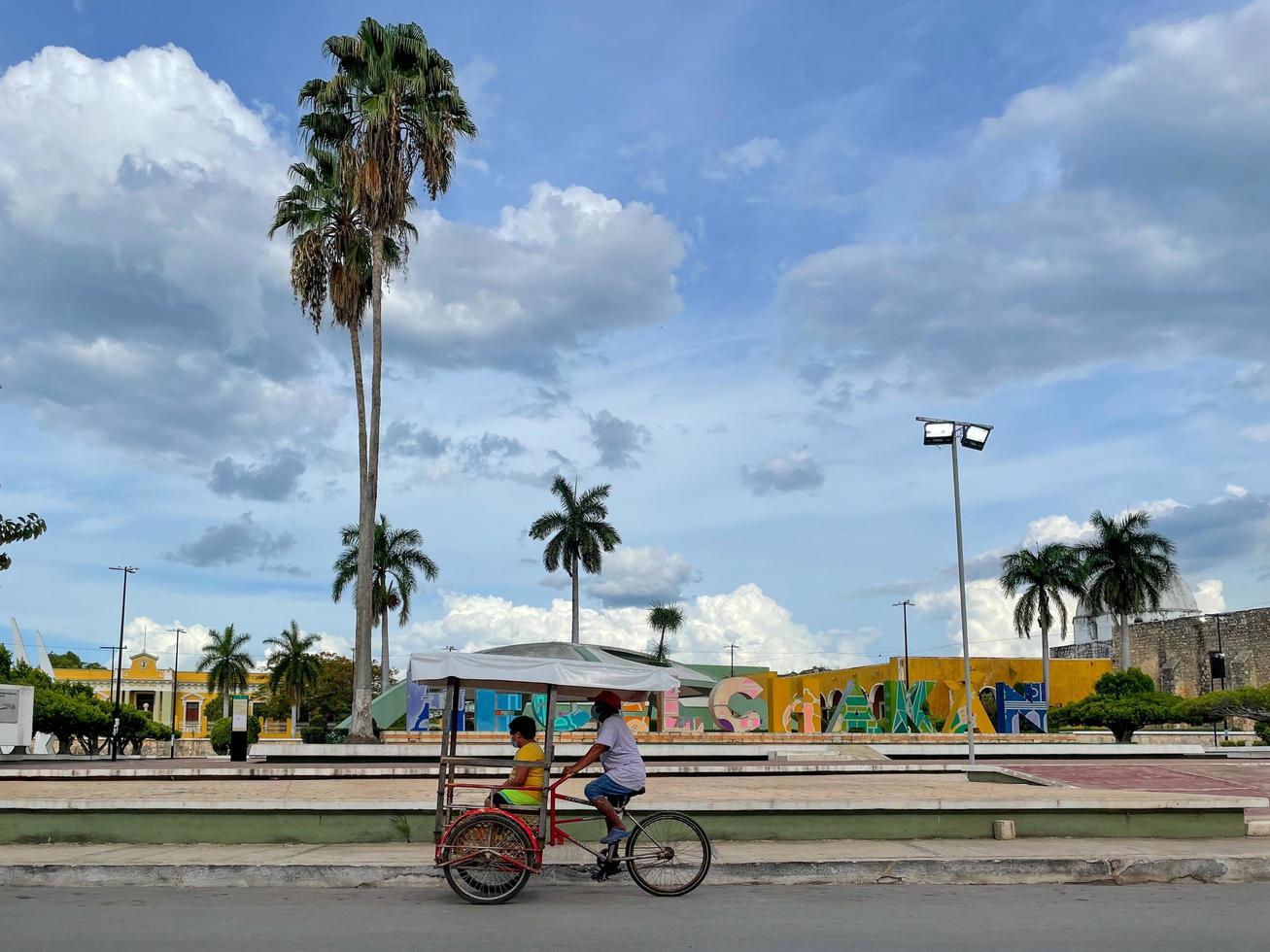 Hecelchakan Mexico  May 26 2021   Bicycle taxi by the colorful letters of the city of Hecelchakan in Campeche Mexican photo