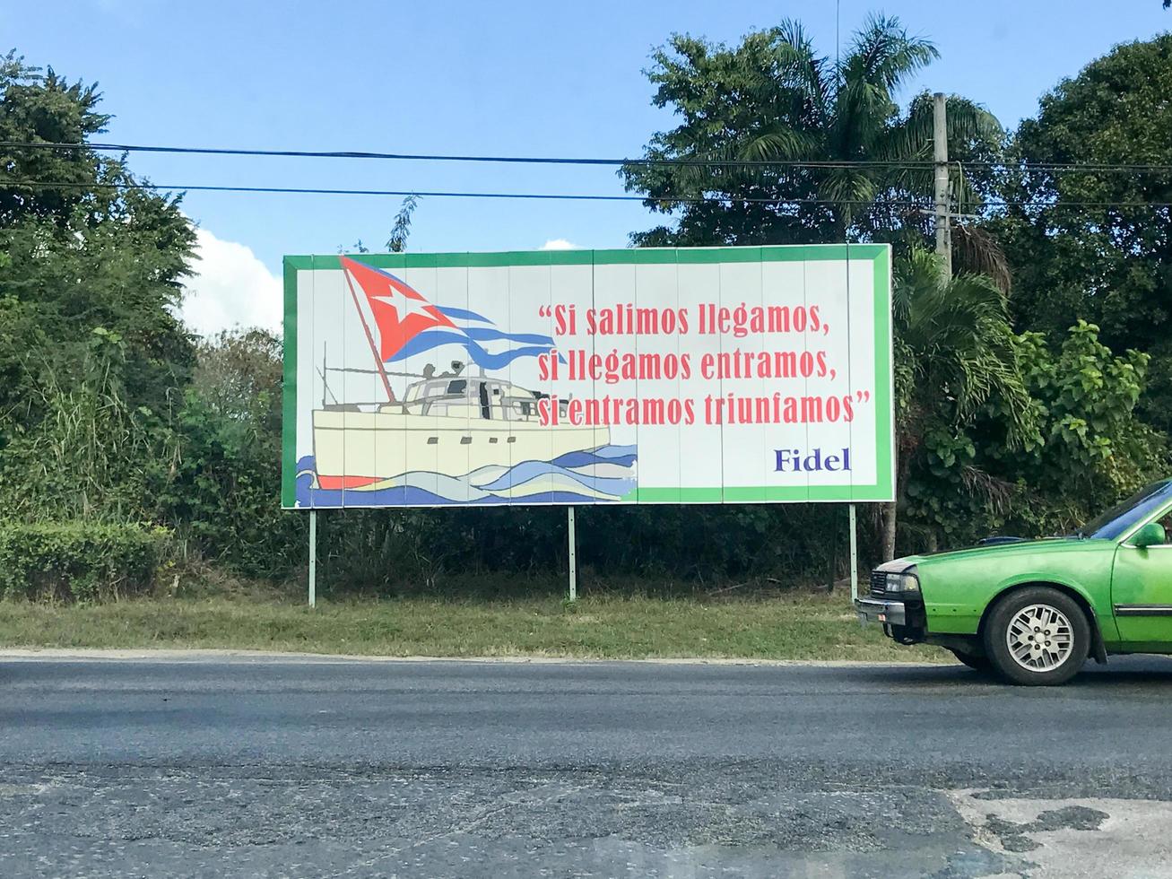 Communist propoganda sign along the road in Cuba writing If we leave we arrive if we arrive we enter if we enter we triumph by Fidel Castro photo