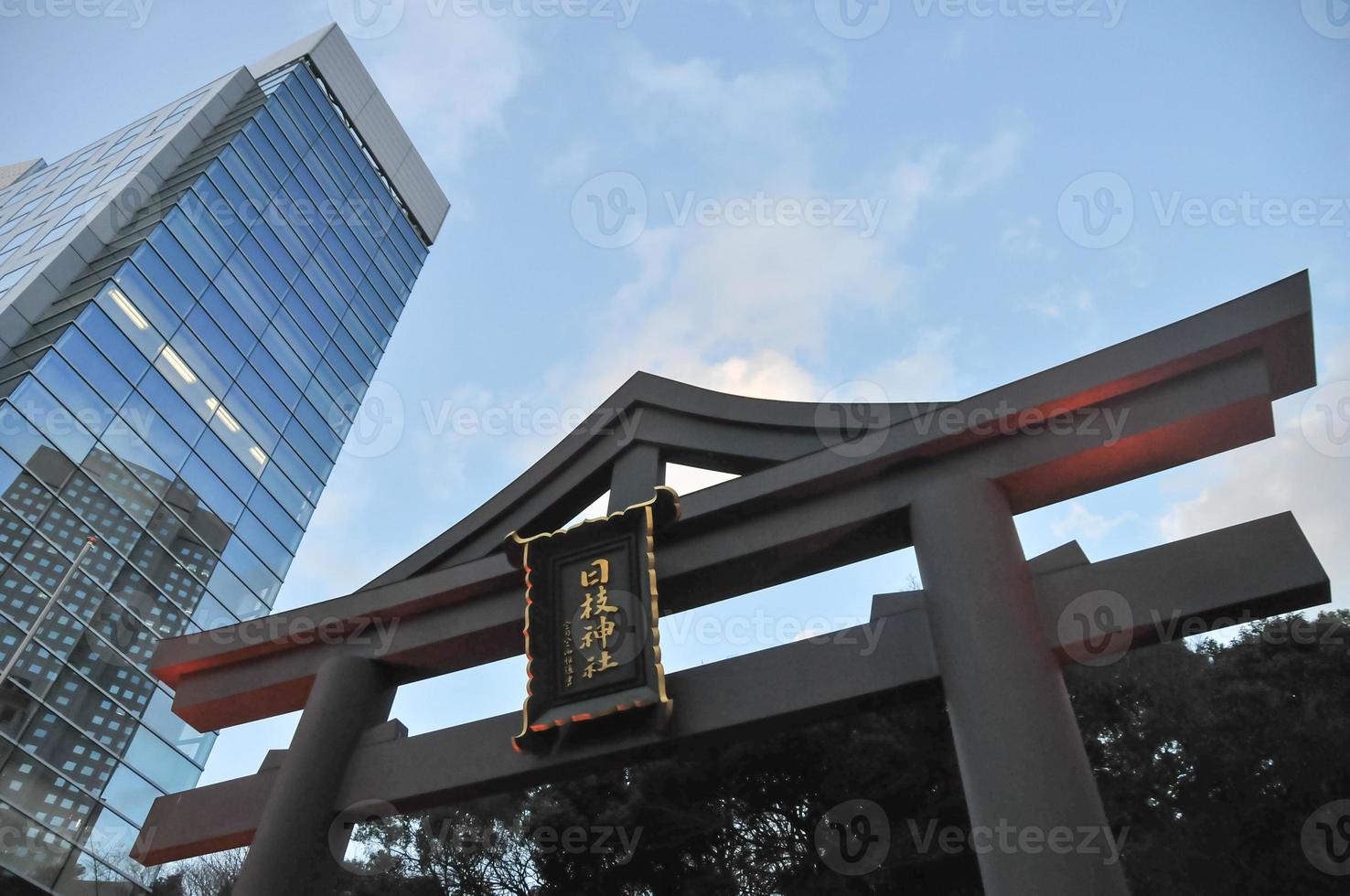 Entrance to the Hie Jinja Shrine The Hie Shrine is a Shinto shrine in Nagatacho Chiyoda Tokyo Japan Juxtaposed with a modern skyscraper behind it photo