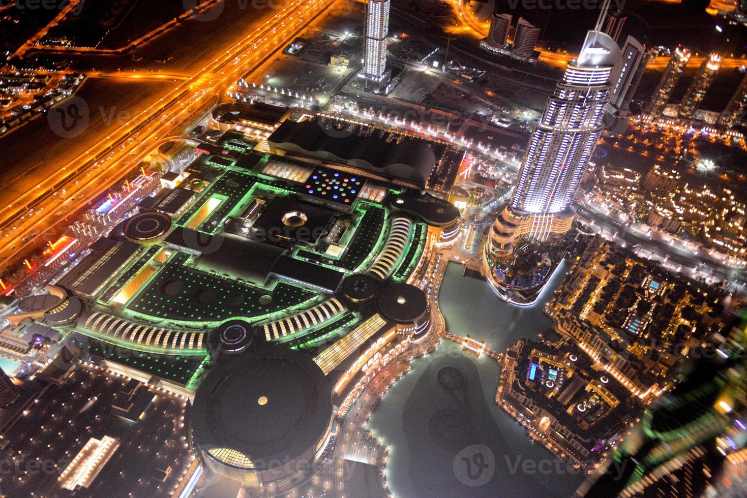 Aerial view of the skyline in Dubai United Arab Emirates at night photo