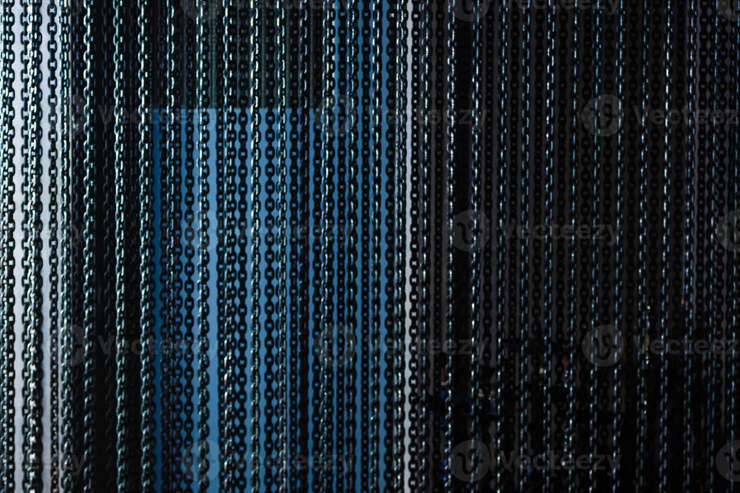image of five hanged metallic chain on a blue background photo