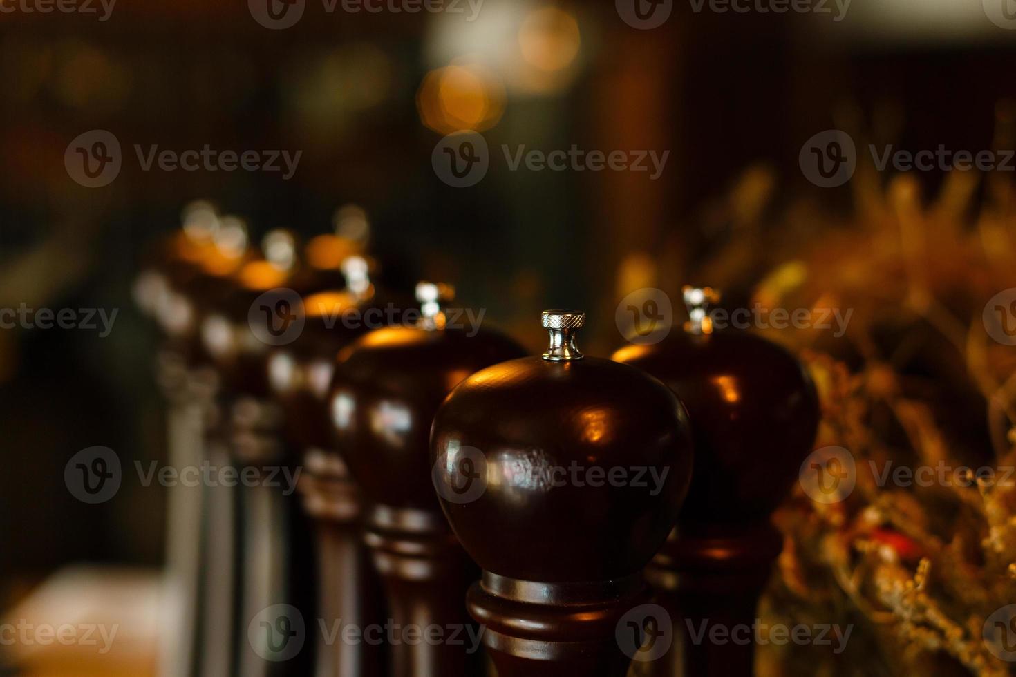 Salt and pepper shakers. Scattered around the spices on a wooden table. photo