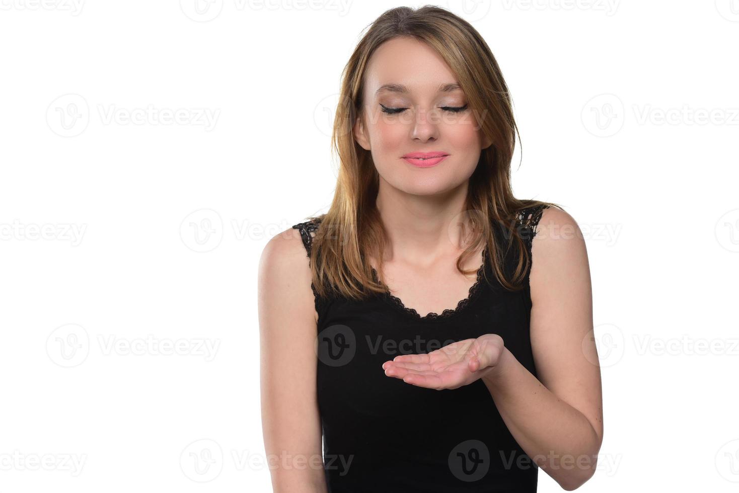 Portrait of young beautiful woman holding imaginary object on the palm .isolated on white photo